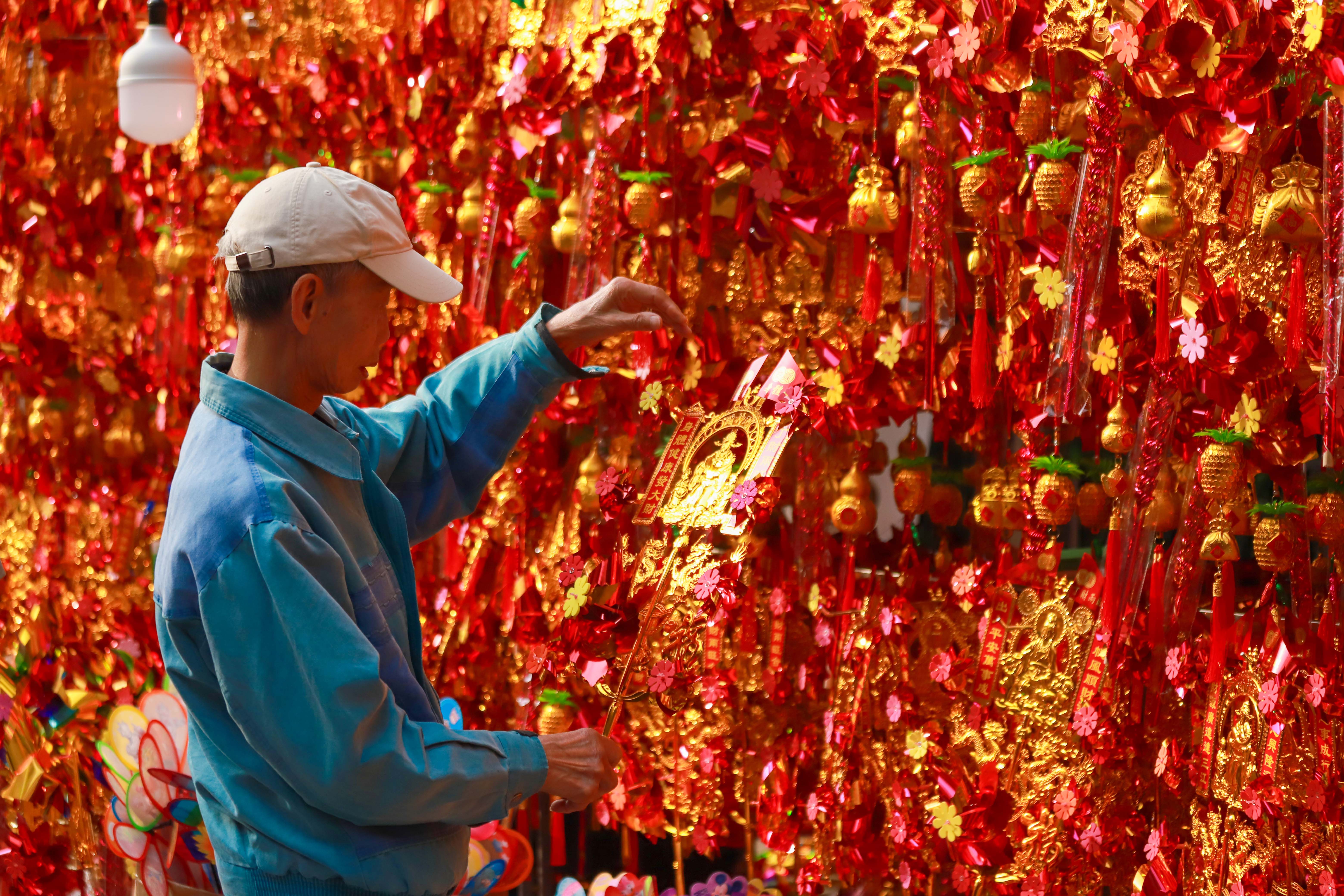 在南海神廟東面的美食市集，街面彩旗飄揚，紅燈籠、油紙傘、各式精美花燈也高高懸掛著，一派喜慶景象。楊文濤攝